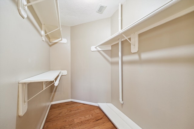 spacious closet with hardwood / wood-style floors