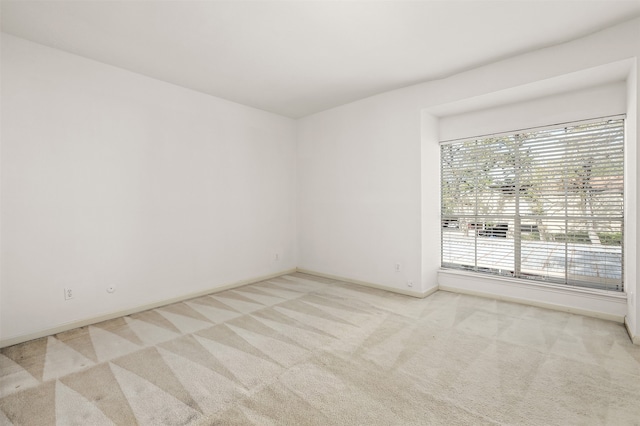 empty room with light colored carpet