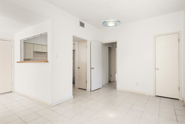 spare room with light tile patterned floors