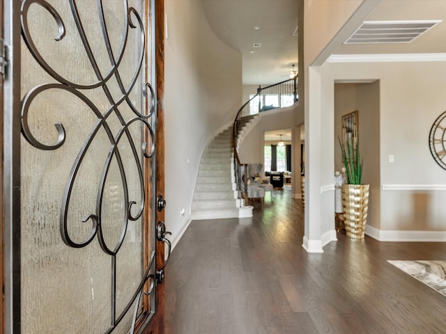 foyer entrance featuring ceiling fan, dark hardwood / wood-style flooring, and ornamental molding