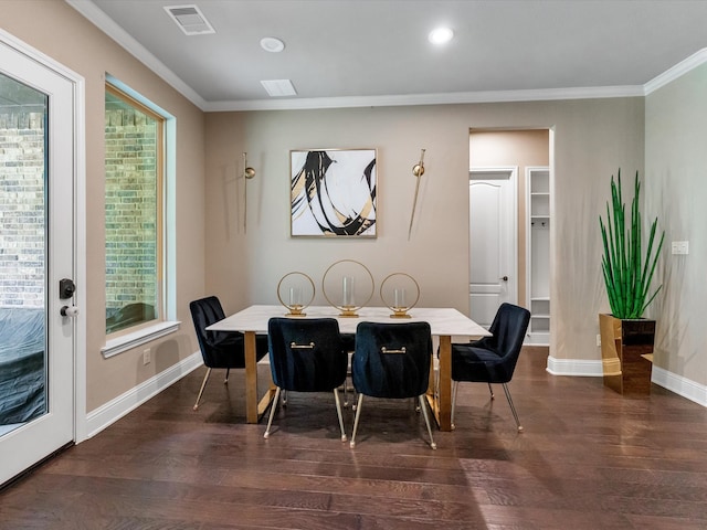 dining room with dark wood-type flooring and ornamental molding