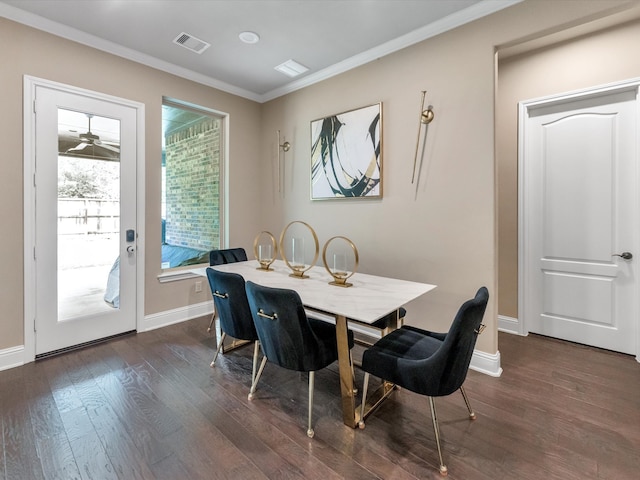 dining room with dark hardwood / wood-style flooring and ornamental molding