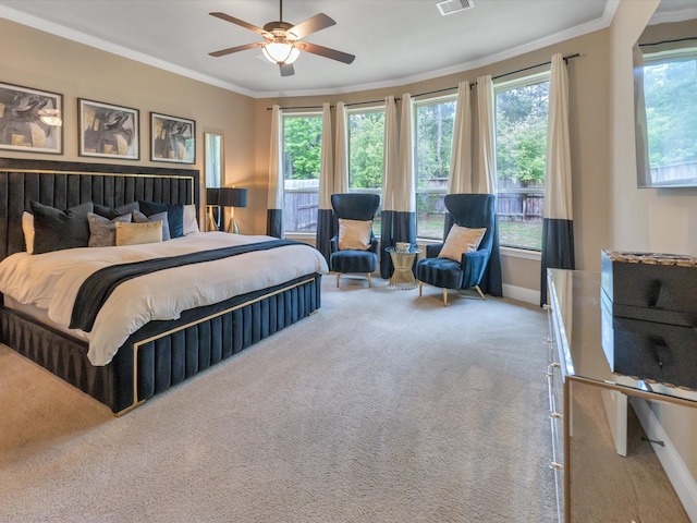 carpeted bedroom with ceiling fan and crown molding