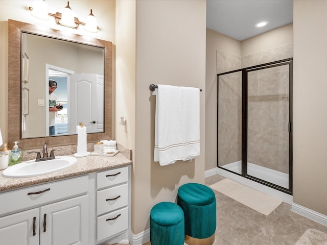 bathroom featuring vanity, tile patterned floors, and walk in shower