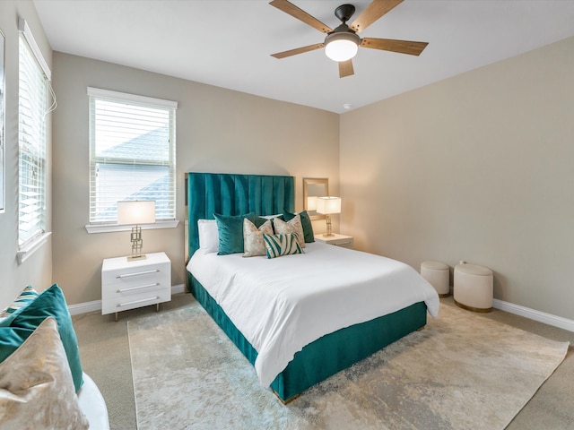 bedroom featuring light carpet and ceiling fan