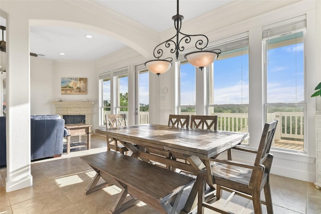 dining area with a healthy amount of sunlight and ornamental molding