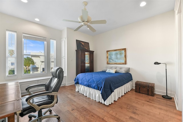 bedroom with ceiling fan and light hardwood / wood-style floors