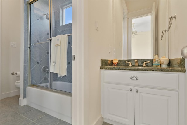 full bathroom with tile patterned floors, vanity, toilet, and enclosed tub / shower combo