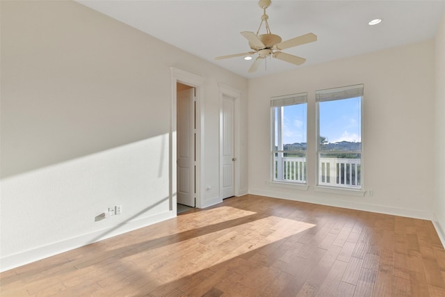 unfurnished room featuring ceiling fan and light hardwood / wood-style floors