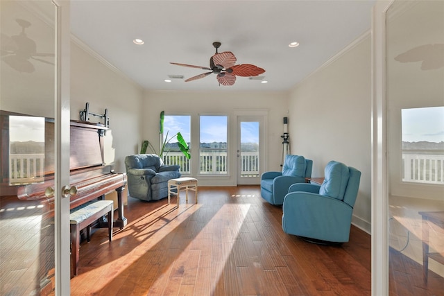 sitting room with ceiling fan, hardwood / wood-style floors, and crown molding