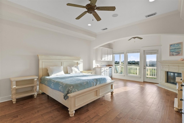 bedroom with dark hardwood / wood-style floors, ceiling fan, and crown molding