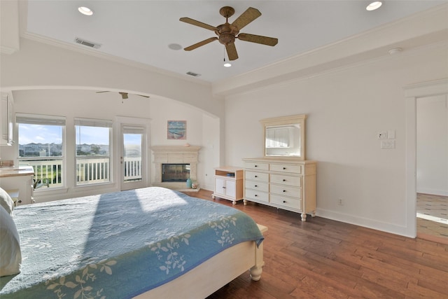 bedroom featuring ceiling fan, dark hardwood / wood-style flooring, and crown molding