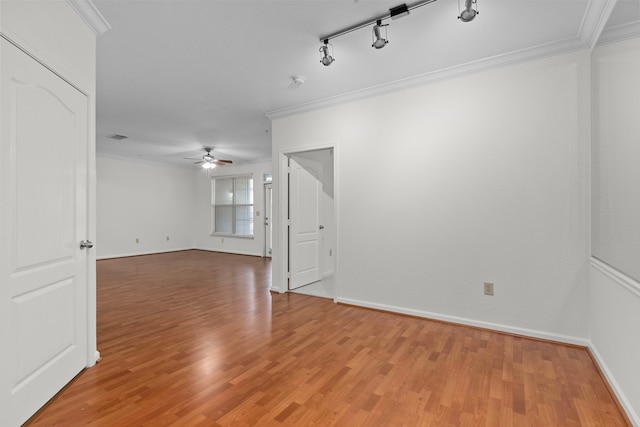 unfurnished room featuring hardwood / wood-style flooring, ceiling fan, crown molding, and rail lighting