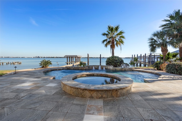 view of swimming pool with a water view and an in ground hot tub