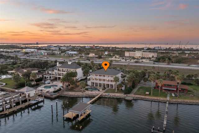 aerial view at dusk with a water view