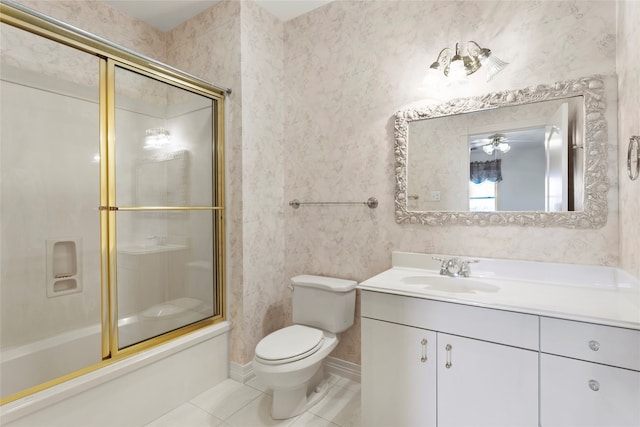 full bathroom featuring vanity, tile patterned floors, bath / shower combo with glass door, ceiling fan, and toilet