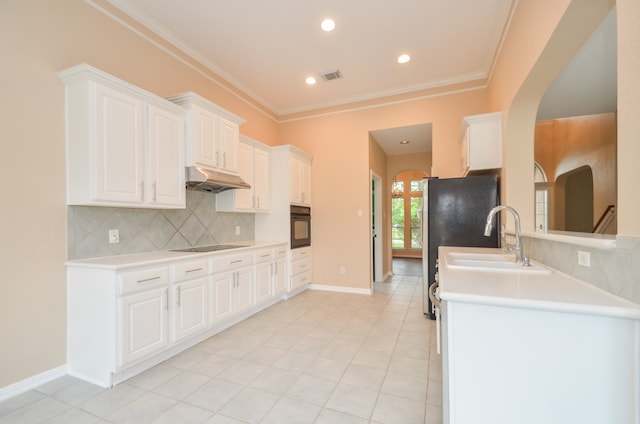 kitchen with backsplash, ornamental molding, sink, black appliances, and white cabinets