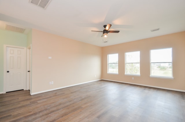 unfurnished room with hardwood / wood-style floors and ceiling fan