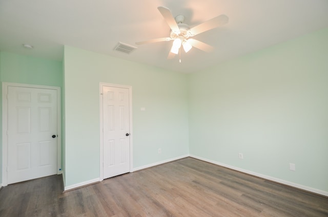 empty room featuring ceiling fan and hardwood / wood-style flooring