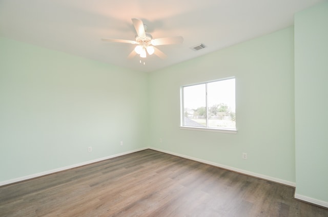 empty room with hardwood / wood-style floors and ceiling fan