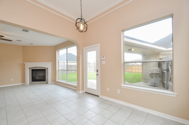 unfurnished living room with light tile patterned floors and ornamental molding