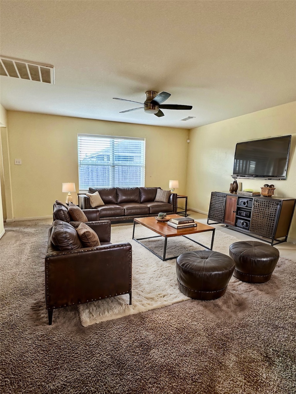 living room featuring carpet and ceiling fan