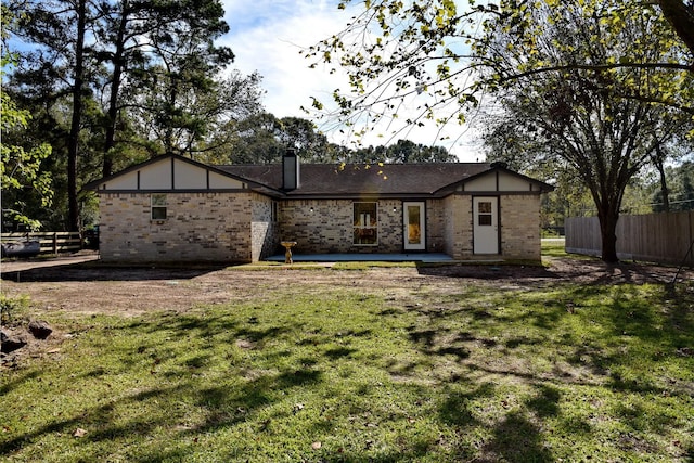 back of house with a yard and a patio area