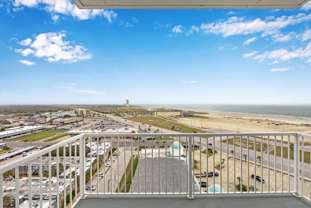 balcony with a water view and a beach view