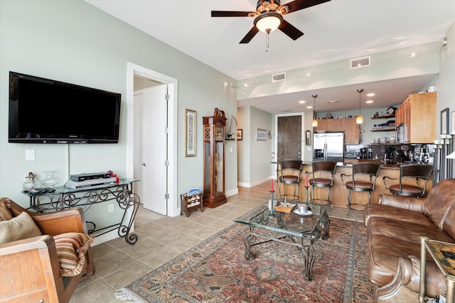 tiled living room with ceiling fan