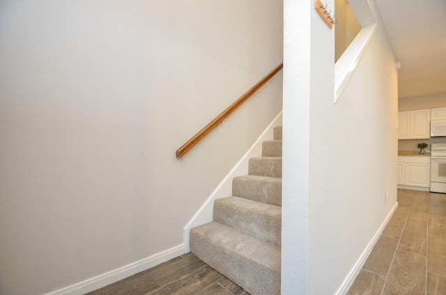 stairs featuring wood-type flooring