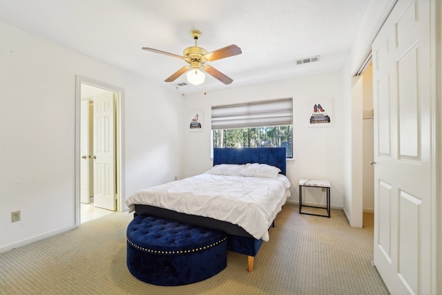 bedroom with ceiling fan and light colored carpet