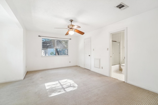 unfurnished bedroom with connected bathroom, ceiling fan, a closet, and light carpet