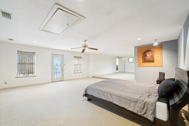 carpeted bedroom with a textured ceiling, access to outside, and ceiling fan