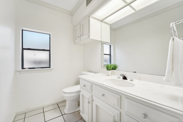 bathroom with toilet, tile patterned flooring, a healthy amount of sunlight, and ornamental molding