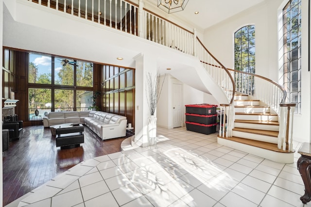 interior space with a high ceiling, hardwood / wood-style flooring, and ceiling fan