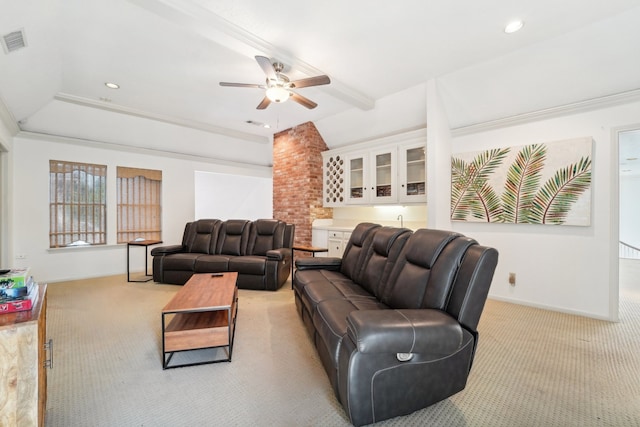 carpeted living room with ceiling fan, beam ceiling, crown molding, and bar