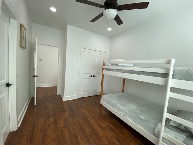 unfurnished bedroom with a closet, ceiling fan, and dark hardwood / wood-style flooring