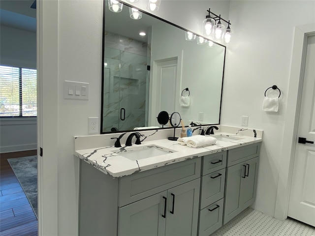 bathroom featuring hardwood / wood-style flooring, vanity, and walk in shower