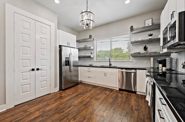 kitchen with white cabinetry, sink, stainless steel appliances, and dark hardwood / wood-style floors