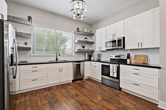 kitchen featuring dark hardwood / wood-style floors, sink, white cabinetry, and stainless steel appliances