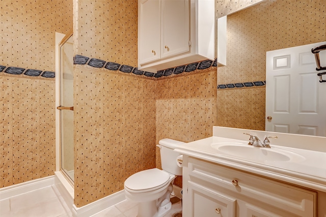 bathroom featuring tile patterned floors, vanity, toilet, and walk in shower