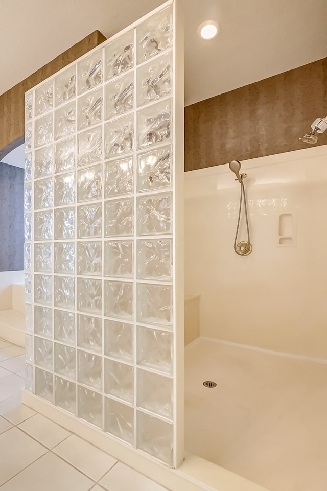 bathroom with tile patterned flooring and walk in shower