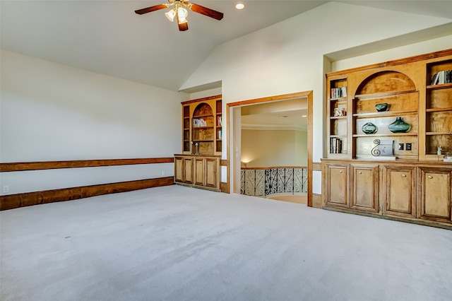 empty room with carpet, built in features, and lofted ceiling