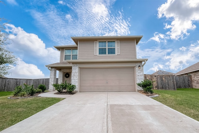 view of property with a front yard and a garage