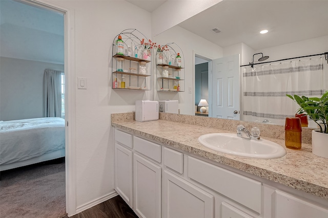 bathroom featuring a shower with shower curtain, wood-type flooring, and vanity