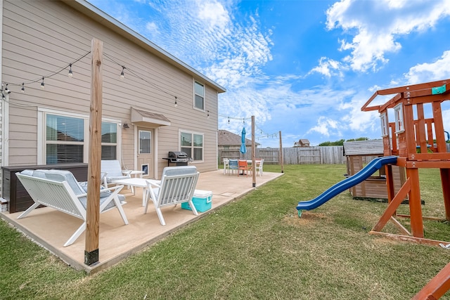 view of jungle gym with a lawn and a patio area