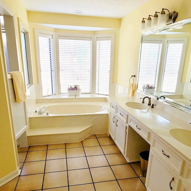 bathroom with tile patterned flooring, vanity, and a tub