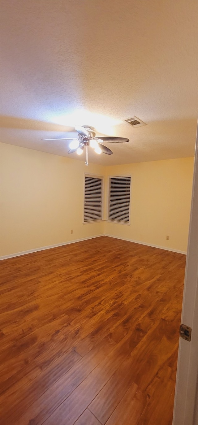 spare room with hardwood / wood-style flooring and a textured ceiling