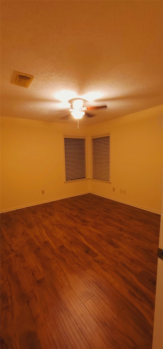 spare room with hardwood / wood-style floors and a textured ceiling