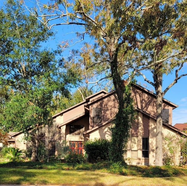 view of property exterior featuring a lawn